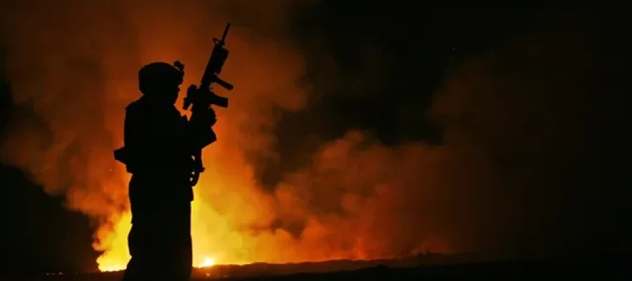 The Aftermath of Toxic Exposure. A Service Member stands in front of a Burn Pit overseas.