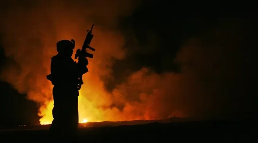 The Aftermath of Toxic Exposure. A Service Member stands in front of a Burn Pit overseas.