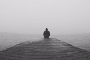 Man Sitting On Pier
