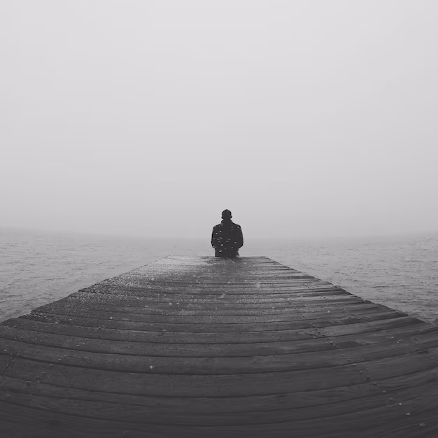 Man Sitting On Pier